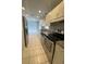 Efficient kitchen with stainless steel appliances, light cabinets and tile flooring at 3231 Cambridge Dr, Sarasota, FL 34232