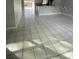 Bright open-concept living room featuring neutral walls and large tile flooring at 3231 Cambridge Dr, Sarasota, FL 34232