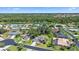 Beautiful aerial view of a residential neighborhood with mature trees and a lake at 3335 Meadow Run Ter, Venice, FL 34293