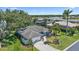 Aerial view of a well-maintained home with a spacious yard, mature trees, and a charming neighborhood setting at 3335 Meadow Run Ter, Venice, FL 34293