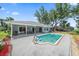 Exterior view of backyard featuring an in-ground pool and covered patio at 3335 Meadow Run Ter, Venice, FL 34293