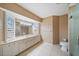 Bright bathroom featuring a double-sink vanity, tile flooring, and a glass-enclosed walk-in shower at 3335 Meadow Run Ter, Venice, FL 34293