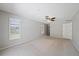 Bedroom with a ceiling fan, neutral walls, carpet, shuttered windows and a door leading to the hall at 3335 Meadow Run Ter, Venice, FL 34293