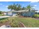 Inviting single-story home with a landscaped yard featuring a lovely garden and an attached two-car garage at 3335 Meadow Run Ter, Venice, FL 34293