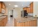 Kitchen with granite countertops, wood cabinets and stainless steel appliances at 3335 Meadow Run Ter, Venice, FL 34293