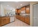 Bright kitchen featuring tile flooring, wood cabinets, stainless steel appliances, and granite countertops at 3335 Meadow Run Ter, Venice, FL 34293