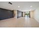 Open living space with tile flooring, recessed lighting, dark accent wall and sliding doors to backyard and pool at 3335 Meadow Run Ter, Venice, FL 34293
