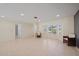 Bright living room featuring tile flooring, recessed lighting, and a large bay window providing ample natural light at 3335 Meadow Run Ter, Venice, FL 34293