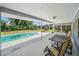 Covered patio with table and chairs overlooking a pool and backyard at 3335 Meadow Run Ter, Venice, FL 34293