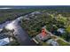 Aerial view featuring a waterfront home with a private boat dock and swimming pool at 3620 Como St, Port Charlotte, FL 33948