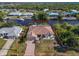 Aerial view of waterfront home with pool, dock, and lush landscaping at 3620 Como St, Port Charlotte, FL 33948