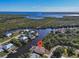 Aerial view features a canal-front home with a pool and dock surrounded by lush landscaping at 3620 Como St, Port Charlotte, FL 33948