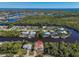 Scenic aerial view showcases a home in a neighborhood surrounded by canals and waterfront properties at 3620 Como St, Port Charlotte, FL 33948