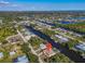 Extensive aerial captures a home set among a network of winding canals in a waterfront community at 3620 Como St, Port Charlotte, FL 33948