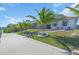 The property has a lush lawn, waterfront access, and a screened in pool at 3620 Como St, Port Charlotte, FL 33948