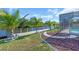 Lush lawn extends to the waterfront, with a view of the pool and dock area at 3620 Como St, Port Charlotte, FL 33948