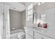 Bathroom featuring a bathtub/shower combination with white shower curtain and a white vanity at 3620 Como St, Port Charlotte, FL 33948