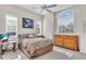 Inviting bedroom with an elegant dresser, a ceiling fan, and a television at 3620 Como St, Port Charlotte, FL 33948