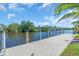 Beautiful view of the boat dock extending to the waterfront; lovely landscaping at 3620 Como St, Port Charlotte, FL 33948
