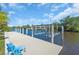 Deep water dock featuring a boat lift and seating area to sit and enjoy waterfront views at 3620 Como St, Port Charlotte, FL 33948