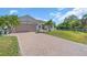 Well maintained residence featuring a tile roof and brick paved driveway leading to a two-car garage at 3620 Como St, Port Charlotte, FL 33948