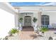 Inviting home entrance with well-manicured landscaping and a beautiful arched entryway at 3620 Como St, Port Charlotte, FL 33948