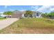 Inviting single-story home with well-manicured lawn, tile roof and attached two-car garage at 3620 Como St, Port Charlotte, FL 33948