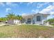Charming single-story home featuring a tile roof, lush landscaping, and a two-car garage at 3620 Como St, Port Charlotte, FL 33948