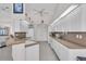 Bright kitchen featuring white cabinets, tiled flooring, neutral countertops, and modern appliances at 3620 Como St, Port Charlotte, FL 33948