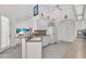 Well-lit kitchen with white cabinets, neutral countertops, tile flooring, and modern appliances at 3620 Como St, Port Charlotte, FL 33948