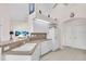 Bright kitchen with white cabinetry, tiled flooring, neutral countertops, and modern appliances at 3620 Como St, Port Charlotte, FL 33948