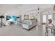 Open living room with tile floors, modern furniture, and natural light from large windows at 3620 Como St, Port Charlotte, FL 33948