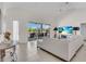 Bright living room with a plush sofa, modern entertainment center, and sliding glass doors to the lanai at 3620 Como St, Port Charlotte, FL 33948