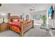 Spacious primary bedroom featuring a king bed, ceiling fan, and natural light from the windows at 3620 Como St, Port Charlotte, FL 33948