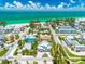 Stunning aerial view of a beautiful beach neighborhood and stylish home with lush landscaping at 3702 5Th Ave, Holmes Beach, FL 34217