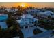 Coastal home with lush landscaping, paver driveway and sunset views at 3702 5Th Ave, Holmes Beach, FL 34217