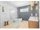 This modern bathroom features a separate shower and tub, dual sinks, and modern fixtures at 3702 5Th Ave, Holmes Beach, FL 34217