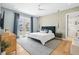 This primary bedroom features beautiful wood floors, a walk-out balcony, and an ensuite bathroom at 3702 5Th Ave, Holmes Beach, FL 34217