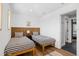 Bright bedroom with twin beds, wooden headboards, and hard floors and stylish decor at 3702 5Th Ave, Holmes Beach, FL 34217