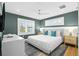 This well-lit bedroom features large windows, a ceiling fan, and modern furnishings at 3702 5Th Ave, Holmes Beach, FL 34217