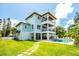 Charming exterior view of the house with a pool, covered patio, rooftop deck, and manicured lawn at 3702 5Th Ave, Holmes Beach, FL 34217