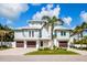 Charming two-story home with three-car garage, a lovely lawn, and stylish coastal design at 3702 5Th Ave, Holmes Beach, FL 34217