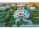 Beautiful exterior view of the home with a rooftop deck, balcony, pool, and lush landscaping at 3702 5Th Ave, Holmes Beach, FL 34217