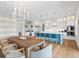 Open-concept kitchen with a large island, stainless steel appliances, and a stylish dining area at 3702 5Th Ave, Holmes Beach, FL 34217