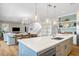 Bright, open-concept kitchen with a large island, modern appliances, and stylish pendant lighting at 3702 5Th Ave, Holmes Beach, FL 34217