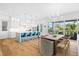 Bright, open kitchen and dining area with modern appliances, a central island, and stylish decor at 3702 5Th Ave, Holmes Beach, FL 34217