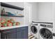 This stylish laundry room is complete with modern appliances, ample counter space, and custom cabinetry at 3702 5Th Ave, Holmes Beach, FL 34217