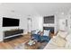 Cozy living room with wood floors, comfortable seating, and an entertainment center with a TV at 3702 5Th Ave, Holmes Beach, FL 34217