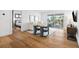 Relaxing living area boasts wood floors, sliding glass doors to the outside, and comfortable seating at 3702 5Th Ave, Holmes Beach, FL 34217