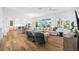 Spacious living room featuring modern decor, a large sectional sofa, and beautiful hardwood floors at 3702 5Th Ave, Holmes Beach, FL 34217
